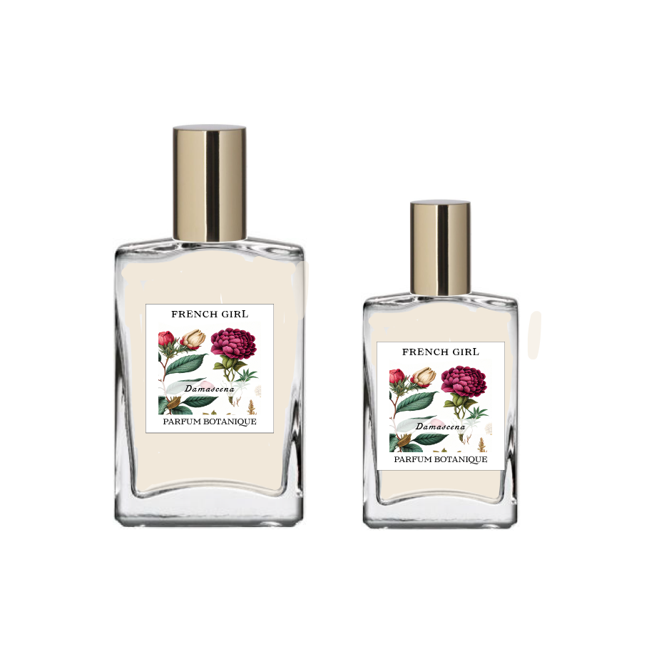 Two clear glass bottles with gold caps, labeled "FRENCH GIRL Damascena Rose Organic Vegan Natural Aromatherapy Perfume," each adorned with floral designs. These luxurious, alcohol-free perfumes are crafted with natural essential oils.