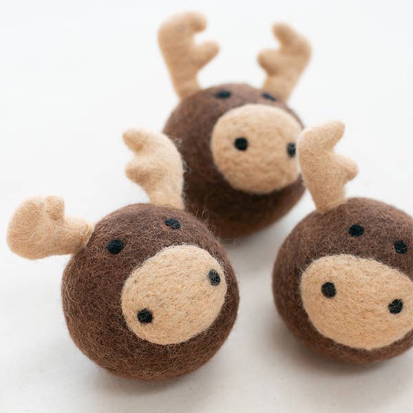 The MODERNBEAST - Moose Beastball Wool Dog Toy features three handmade round brown moose-face balls with beige snouts, black eyes, and felt antlers. Made by MODERNBEAST from eco-friendly New Zealand wool for your dog’s playtime.