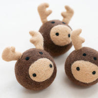The MODERNBEAST - Moose Beastball Wool Dog Toy features three handmade round brown moose-face balls with beige snouts, black eyes, and felt antlers. Made by MODERNBEAST from eco-friendly New Zealand wool for your dog’s playtime.