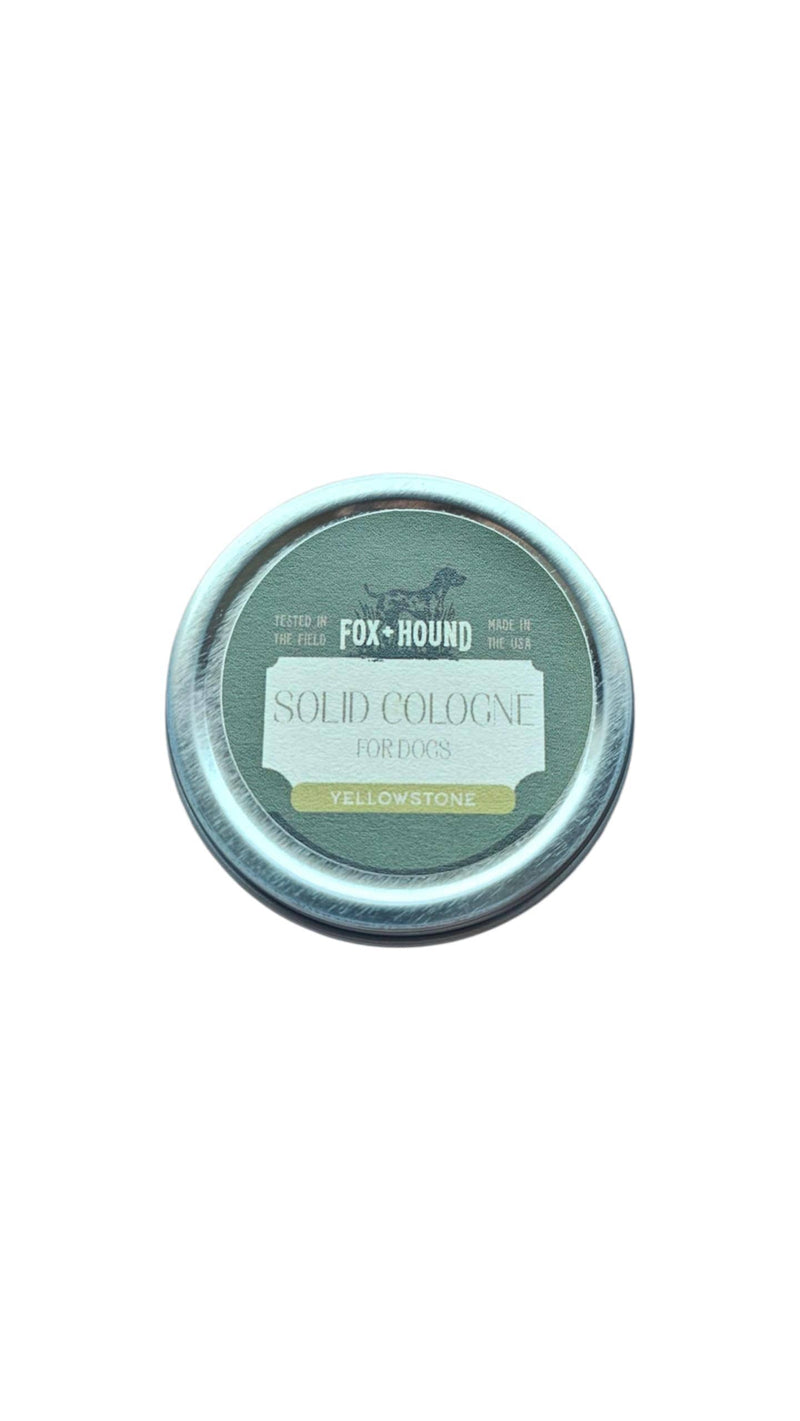 The Fox + Hound Yellowstone Solid Dog Cologne by Fox + Hound comes in a round tin with green and yellow accents, is field-tested, made in the USA, and is ideal for traveling with your dog.