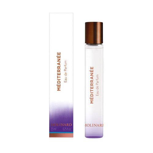 A slender Molinard Méditerranée Eau de Parfum Roll-On stands by its matching box with a copper cap. The box fades from white to purple, reflecting the perfume's elegance, and displays the brand name "Molinard.