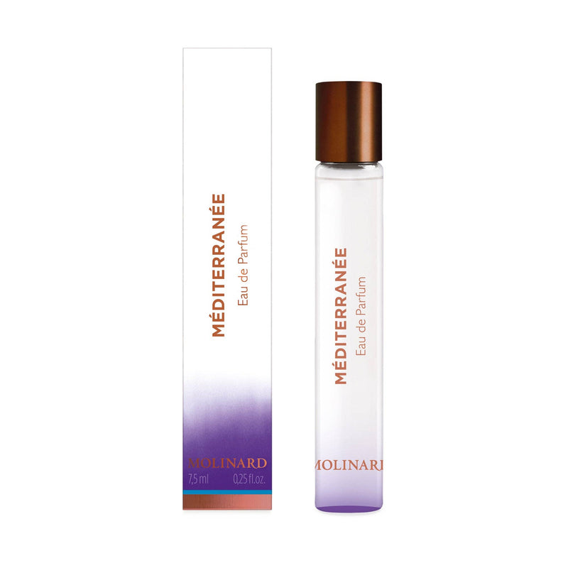 A slender Molinard Méditerranée Eau de Parfum Roll-On stands by its matching box with a copper cap. The box fades from white to purple, reflecting the perfume's elegance, and displays the brand name "Molinard.