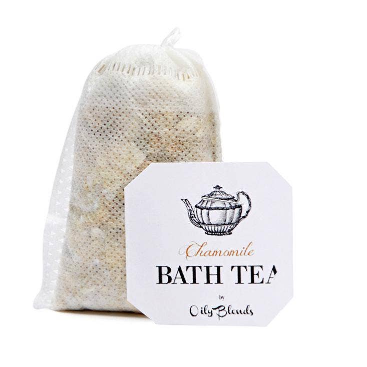 A mesh pouch labeled "Bath Tea Single Bag - Chamomile" features a vintage teapot illustration and is filled with natural chamomile for tranquility. The label displays "Hampton Court," inviting you to enjoy a serene bath tea experience.