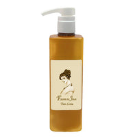 A rectangular amber bottle with a white pump and vintage-style label reading “La Bouquetiere Fleurs du Jour / Marina Blue Body Lotion,” offering an aloe moisturizer and lasting fragrance.