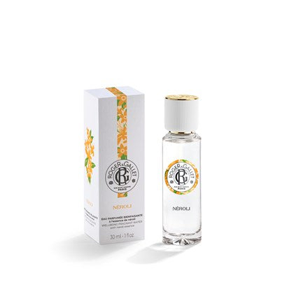 A clear glass bottle of Roger & Gallet Neroli Wellbeing Fragrant Water 1 oz stands beside its white and orange floral-accented box. The perfume features orange blossom notes and has a gold and white cap with the Roger & Gallet logo.