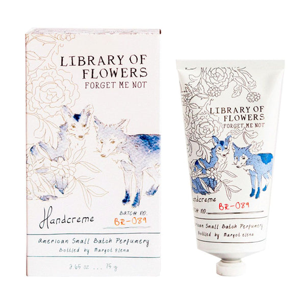 A tube and box of Margot Elena’s Library of Flowers Forget Me Not Hand Creme with blue fox art and floral patterns, enriched with shea butter for soft, fragrant skin. Crafted by an American small-batch perfumery.