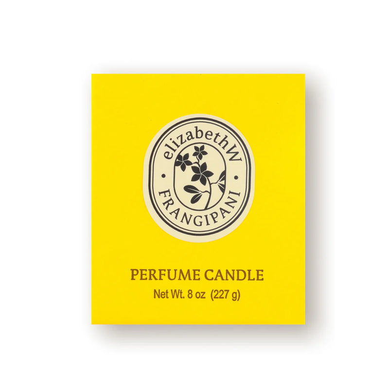 A vibrant yellow box prominently features a round emblem adorned with a branch and leaves, labeled "elizabeth W Botanist's Scent Lab Frangipani Candle." Below, it states "Perfume Candle in Soy Wax, Net Wt. 8 oz (227 g).