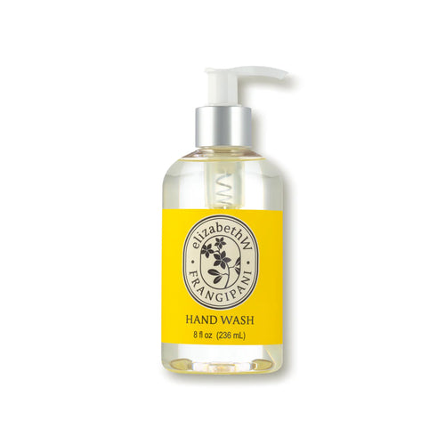 A bottle of elizabeth W Botanist's Scent Lab Frangipani Hand Wash with a pump dispenser. The label is yellow with black text and features a floral design. Infused with a tropical scent, the bottle contains 8 fl oz (236 mL) of liquid hand wash.