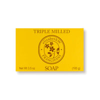 A rectangular yellow package, labeled "elizabeth W Botanist's Scent Lab Frangipani Bar Soap," weighs 3.5 oz (100 g) and features a circular emblem with a flower design in the center. Its exotic allure infuses its triple-milled texture for a luxurious cleanse that evokes the essence of sandalwood.