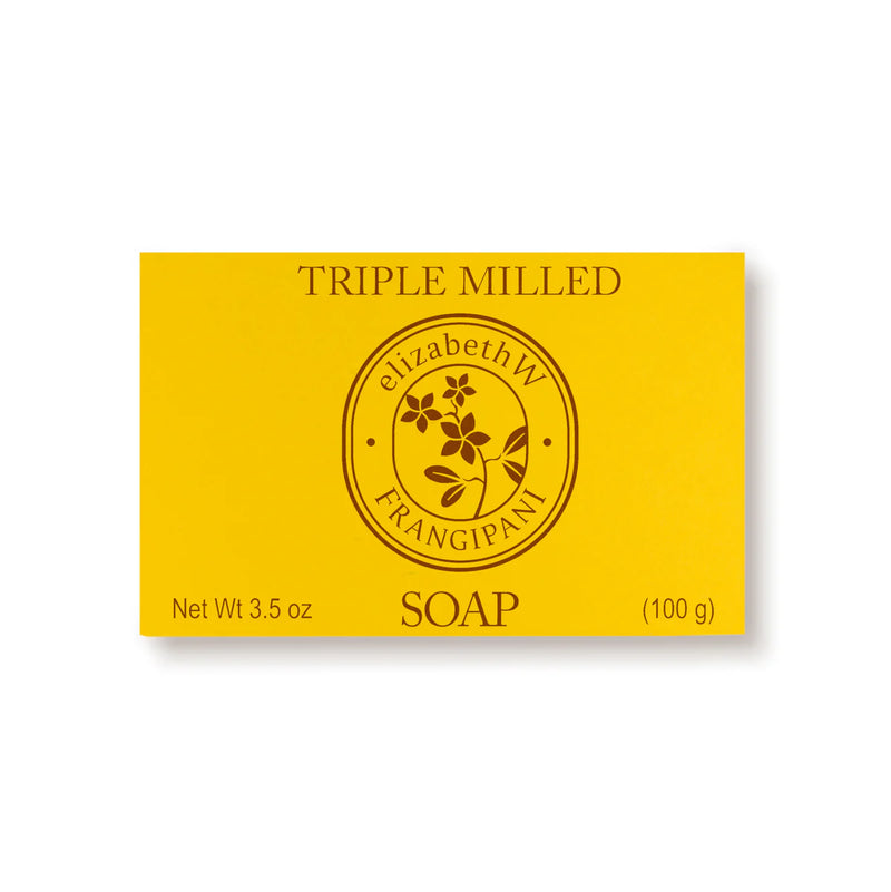 A rectangular yellow package, labeled "elizabeth W Botanist's Scent Lab Frangipani Bar Soap," weighs 3.5 oz (100 g) and features a circular emblem with a flower design in the center. Its exotic allure infuses its triple-milled texture for a luxurious cleanse that evokes the essence of sandalwood.