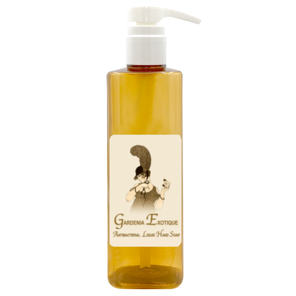 A clear amber pump bottle labeled "La Bouquetiere Gardenia Exotique Antibacterial Liquid Hand Soap" features an exotic styled illustration of a woman holding flowers, standing out as the central image on the label, perfect for those who appreciate a floral fragrance.