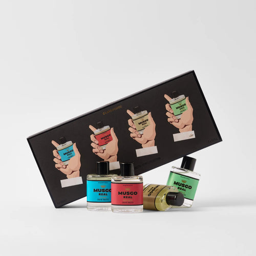 Three bottles of Claus Porto Musgo Real Hands Up Mini EDT by Claus Porto 1887, with blue, red, and green labels, are displayed before a black illustrated gift box—a refined men’s fragrance set.