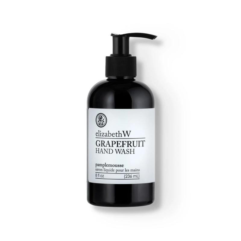 A black pump bottle of elizabeth W Purely Essential Grapefruit Hand Wash with a white label and black text. The label includes English and French text, describing the product as 8 fl oz (236 mL).