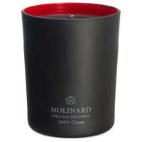 The Molinard Candle - Habanita is a black luxury candle with a red interior, featuring the Molinard name, crest, and "Créateur Parfumeur 1849-Grasse" in white—a signature home fragrance with a distinctive powdery scent.