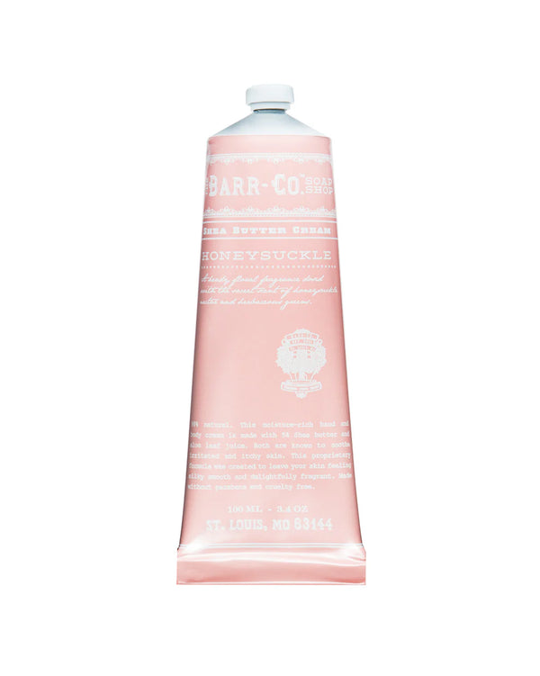 A pink tube of Barr-Co. Honeysuckle Hand & Body Cream stands upright against a white background, with white text on the front displaying the product name and brand.