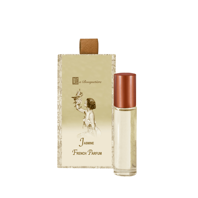 An elegant perfume bottle with a bronze cap is placed next to its beige packaging, which features a vintage-style illustration of a woman holding flowers. The text on the package reads, "La Bouquetiere Jasmine French Perfume." This luxurious scent epitomizes the essence of French perfumery from La Bouquetiere.