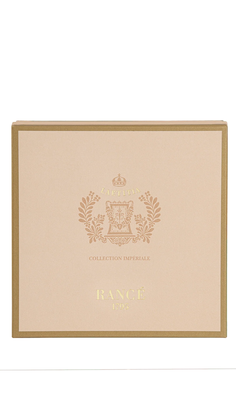 A pink and gold box with ornate floral designs and a central crest suggests luxury soaps. The text "Collection Impériale" and "Rancé 1795" adds vintage charm. Product: Rancé Laetitia Luxury Soap Box by Rancé.