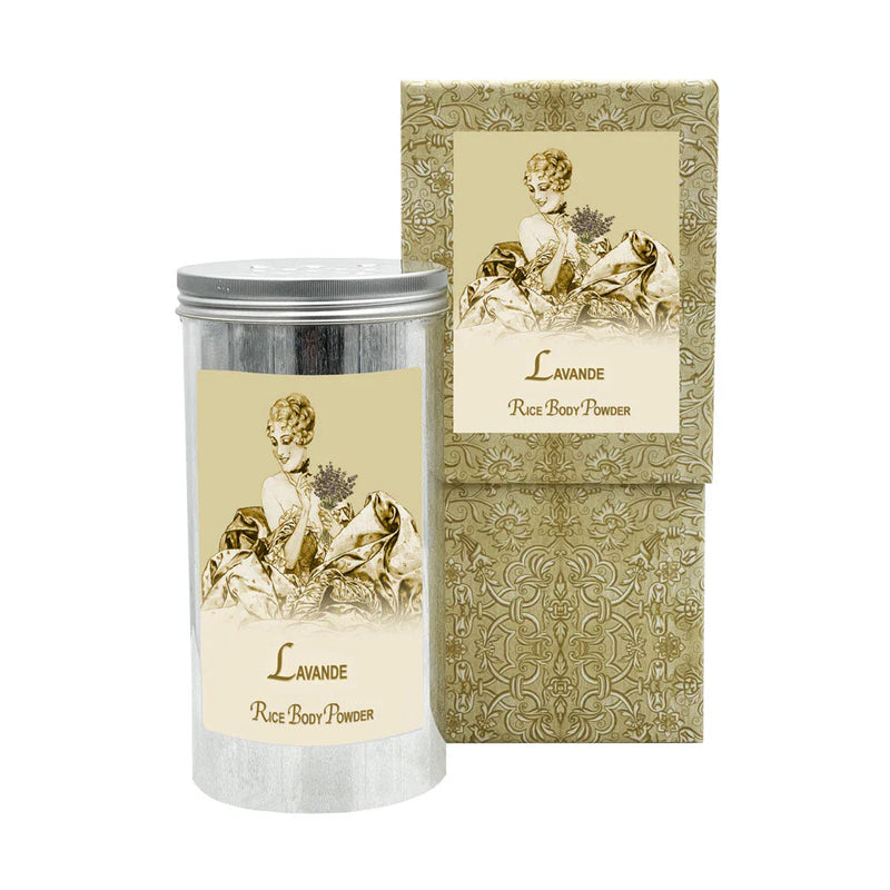 The La Bouquetiere Lavender Rice Body Powder Canister by La Bouquetiere showcases vintage-style packaging with a cylindrical tin and matching box adorned with an illustration of a woman holding flowers. The ornate design features intricate patterns in muted gold and cream colors, highlighting the charm of finely milled rice essence.