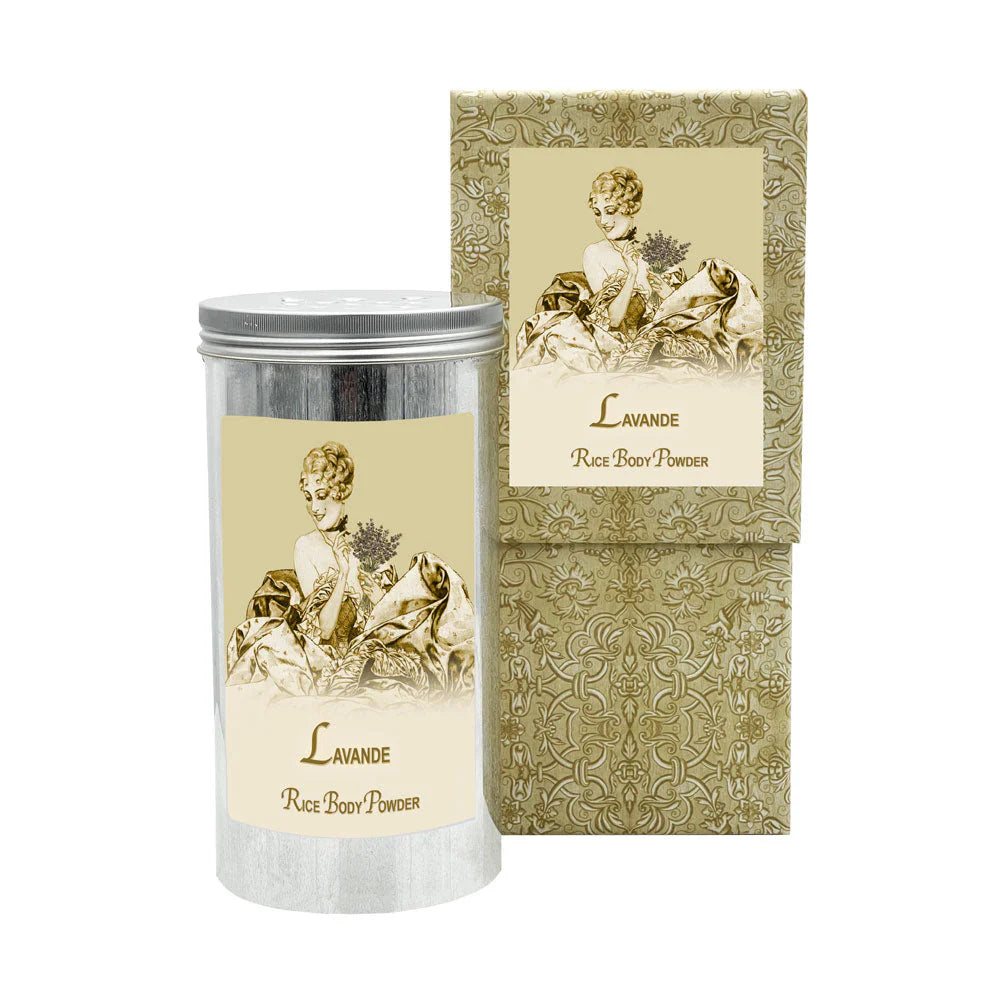 The La Bouquetiere Lavender Rice Body Powder Canister from La Bouquetiere is presented in a vintage-style metallic container adorned with an illustration of a woman holding flowers. The patterned box features an ornate, classic design and the product is infused with essential oils for enhanced care.