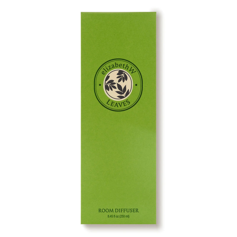 A tall, green rectangular box labeled "elizabeth W Botanist's Scent Lab Leaves Diffuser" with a circular leaf logo. The bottom text reads "ROOM DIFFUSER 8.45 fl oz (250 ml)." Features elizabeth W’s signature leafy fragrance.