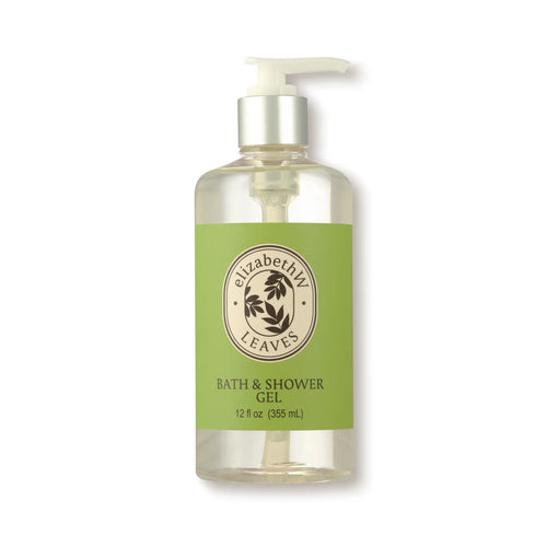 A clear plastic bottle with a white pump dispenser contains elizabeth W's Botanist's Scent Lab Leaves Shower Gel. The label is green with black text and logo. Infused with sandalwood and woody Atlas cedar, the bottle holds 12 fluid ounces (355 mL) of gel.