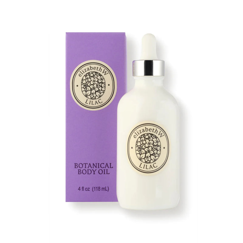 A white bottle with a dropper labeled "elizabeth W Botanist's Scent Lab Lilac Body Oil" stands next to a matching purple box. The box reads "Botanical Scented Oil, 4 fl oz (118 ml)." The design is minimalist and elegant.