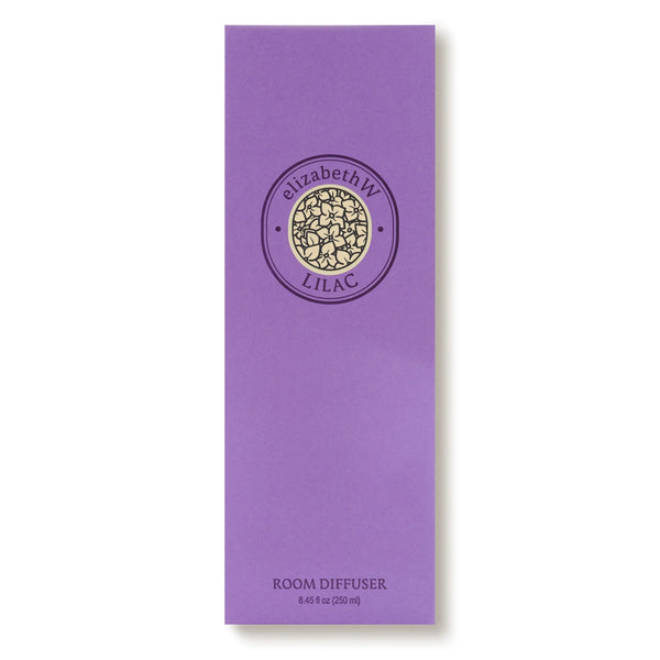 A tall purple box labeled "elizabeth W Botanist's Scent Lab Lilac Diffuser" features a central circular floral design and offers a fresh spring garden scent. "ROOM DIFFUSER 8.45 fl oz (250 ml)" is printed at the bottom.