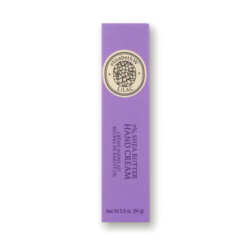 A rectangular, purple box of elizabeth W Botanist's Scent Lab Lilac Hand Cream is pictured. The box is vertically oriented with gold and black text, indicating "77% Shea Butter Hand Cream" and "94g" at the bottom. The hydrating hand cream boasts a lilac fragrance, with the brand's logo elegantly displayed at the top.