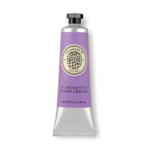 A silver and purple tube of elizabeth W Botanist's Scent Lab Lilac Hand Cream. The hydrating hand cream from elizabeth W features a black cap and is labeled "7% Shea Butter Hand Cream" with a net weight of 3.3 oz (94 g). Enjoy the delicate lilac fragrance as you nourish your skin.