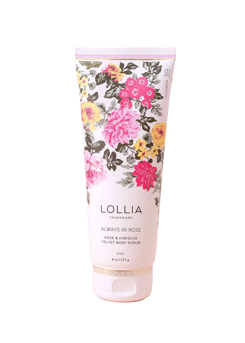 The Margot Elena Lollia Always in Rose Velvet Body Scrub is an 8 oz exfoliant with rose and hibiscus scents, housed in a white tube with pink, yellow, gray floral designs and gold accents. Infused with nourishing botanicals for gentle care.