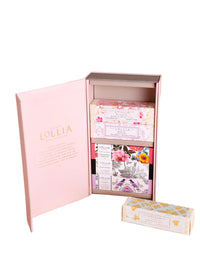 An open pink Lollia box by Margot Elena displays four individually wrapped floral soap bars in purple, pink, yellow, and white—perfect to pair with the Lollia Petite Treat Handcreme Gift Set Asst. 2 for a thoughtful gift.