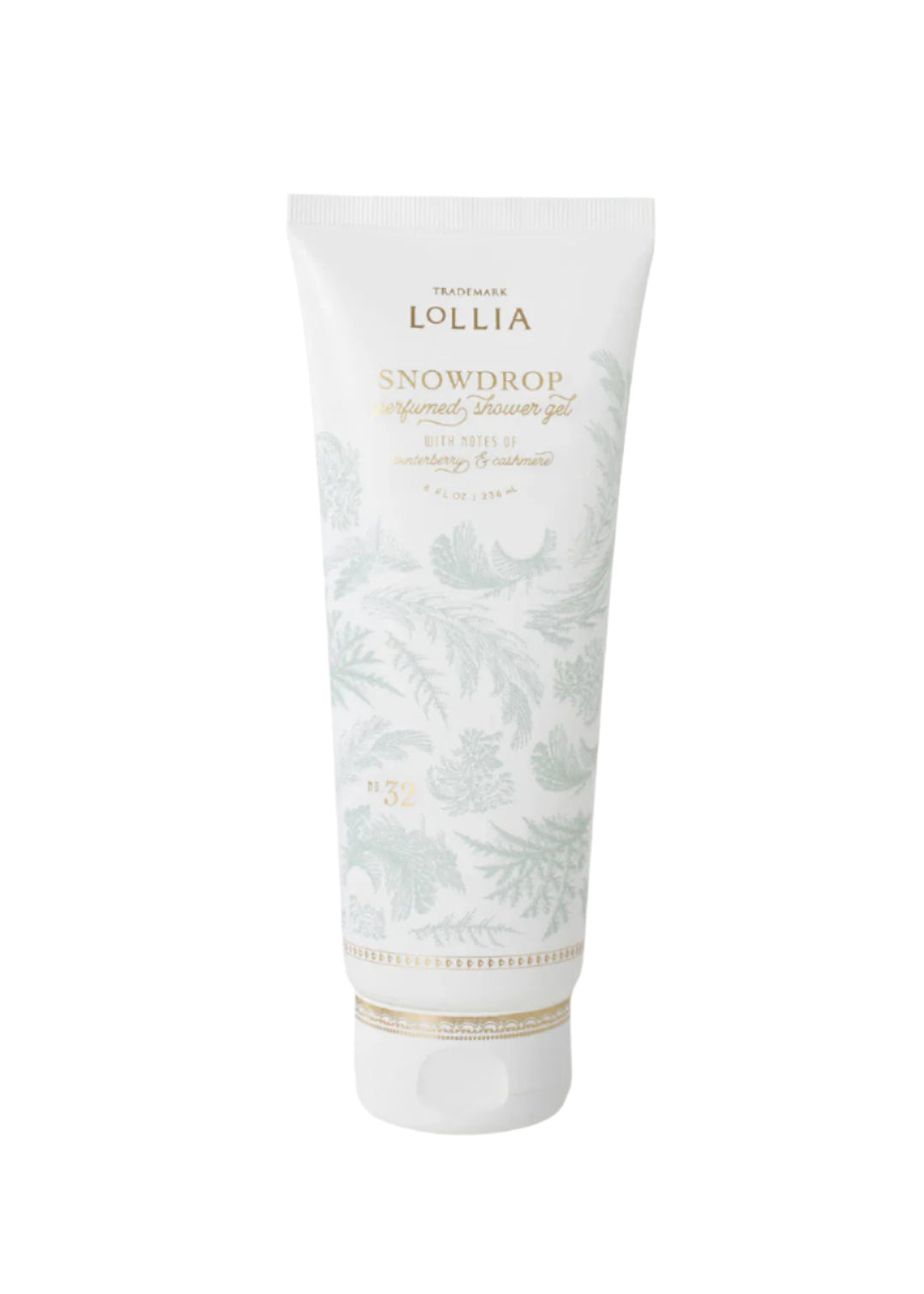 A white tube of Margot Elena's Lollia Snowdrop Perfumed Shower Gel, featuring pale leaf patterns and gold accents, stands upright against a plain white background.