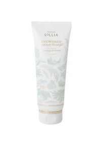 A white tube of Margot Elena's Lollia Snowdrop Perfumed Shower Gel, featuring pale leaf patterns and gold accents, stands upright against a plain white background.