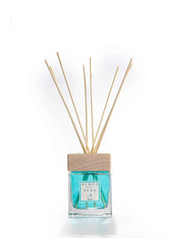 A 200ml Acqua dell'Elba Reed Diffuser Mare from the Acqua dell'Elba brand, infused with the sea essence of Italian island tranquility. It features light blue liquid, a wooden cap, and several natural reed sticks, set against a pristine white background.