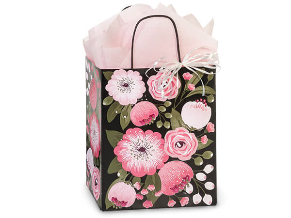 The Moonlit Blooms Paper Gift Bag by Nashville Wraps features pink and white flowers on black, is filled with pale pink tissue, tied with a white ribbon bow, and made from recyclable paper for eco-friendly gifting. Size: 8x4.75x10.25".