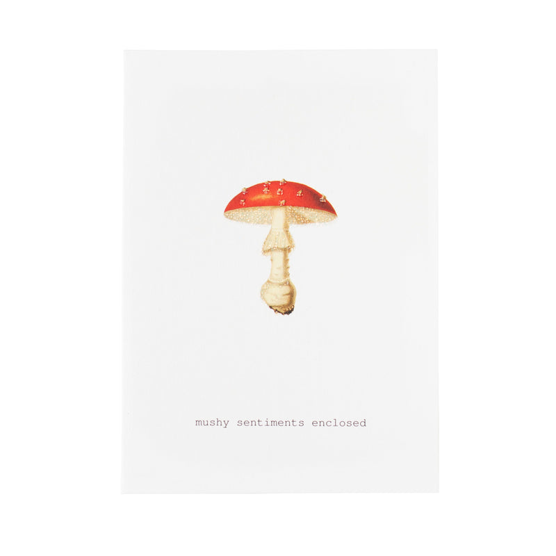 The TokyoMilk Mushy Sentiments Enclosed Greeting Card by Margot Elena features a red and white mushroom illustration with "mushy sentiments enclosed" printed below on textured paper—perfect for heartfelt messages.