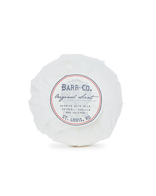 A luxury round bath bomb from Barr-Co., wrapped in white paper featuring "Barr-Co. Original Scent" and "St. Louis, MO," is infused with milk, oatmeal, vanilla, and vetiver aromas.