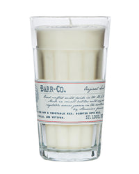 The Barr-Co. Original Scent Parfait Candle is a white soy candle in a tall clear glass with a vintage label, handcrafted for long-lasting burn and features vanilla, oatmeal, and vetiver notes.
