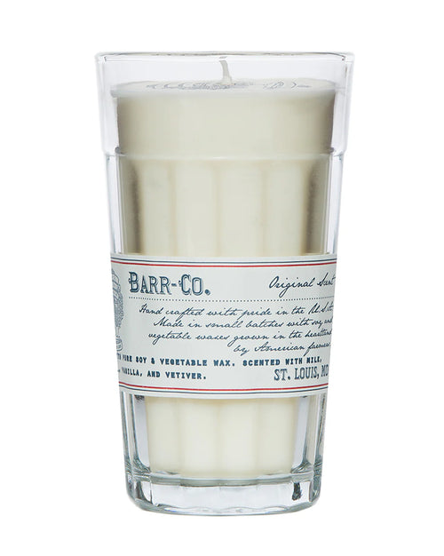 The Barr-Co. Original Scent Parfait Candle is a white soy candle in a tall clear glass with a vintage label, handcrafted for long-lasting burn and features vanilla, oatmeal, and vetiver notes.