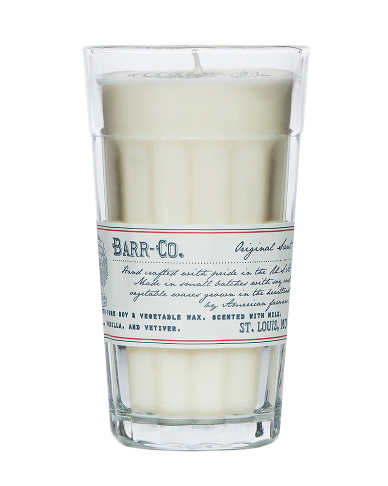The Barr-Co. Original Scent Parfait Candle is a white soy candle in a tall clear glass with a vintage label, handcrafted for long-lasting burn and features vanilla, oatmeal, and vetiver notes.