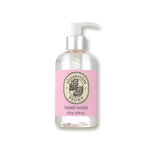 A clear pump bottle containing elizabeth W Botanist's Scent Lab Peony Hand Wash with a pink label. The ornate emblem features the brand name and a peony flower illustration, capturing the floral essence of peony. From elizabeth W, this 8 fl oz (236 mL) hand wash offers a captivating fragrance.