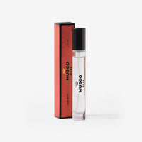 A clear glass bottle of Claus Porto Musgo Real Puro Sangue Eau de Toilette Travel Size by Claus Porto 1887, with a black cap, stands beside its matching red and black box, elegantly displayed on a white background.