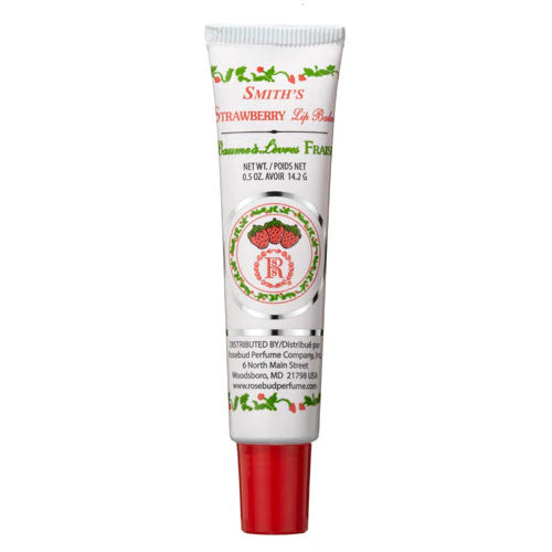 Smith's Rosebud Strawberry Lip Balm features classic white packaging with a red cap, floral design, and Rosebud logo. The tube highlights its strawberry flavor, moisturizing formula, and origin from Rosebud Perfume Co., containing 0.5 oz of product.