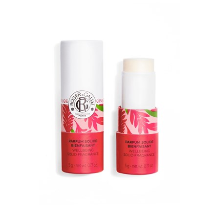 A cylindrical Roger & Gallet Red Ginger Wellbeing Solid Perfume, alcohol-free, with a white cap and pink floral design; one stick is shown closed and another open to display the fragrance inside.