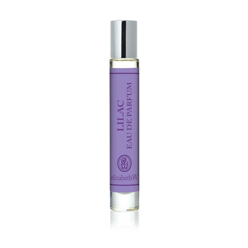 The elizabeth W Botanist's Scent Lab Lilac Rollerball features a clear glass bottle with a silver cap and contains a light purple floral fragrance inspired by botanist scents.