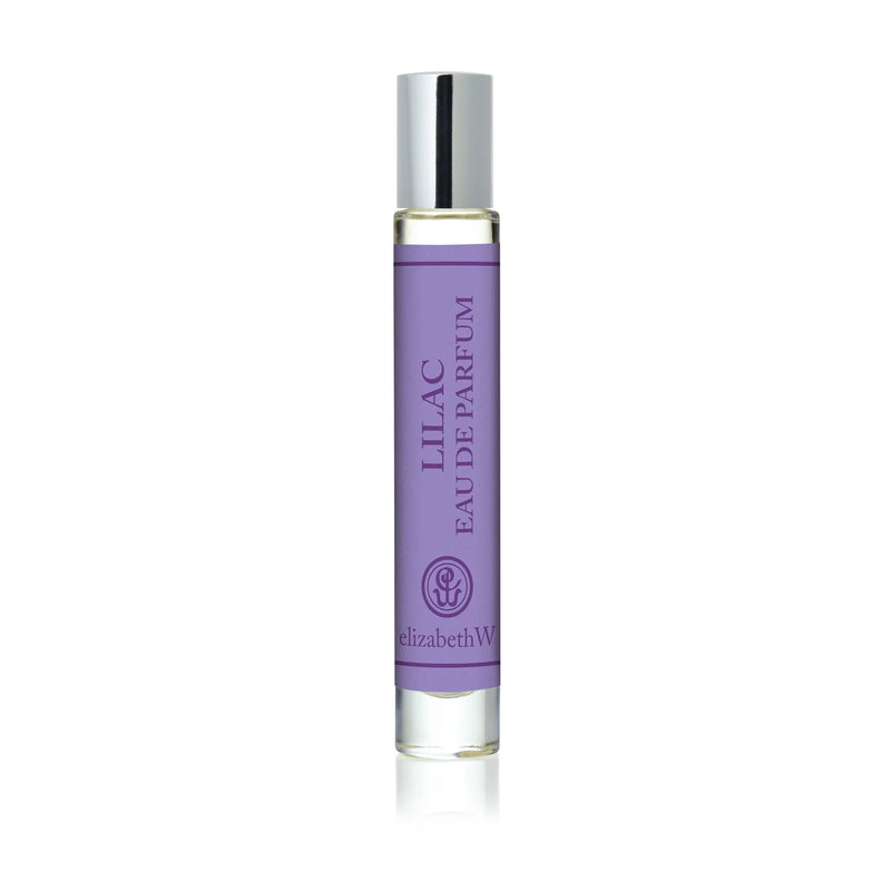 The elizabeth W Botanist's Scent Lab Lilac Rollerball features a clear glass bottle with a silver cap and contains a light purple floral fragrance inspired by botanist scents.