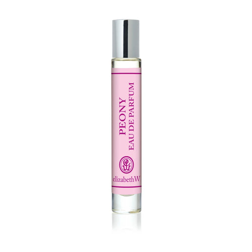 A clear glass rollerball bottle with a silver cap, filled with pink liquid, features a delicate floral scent. The label reads "elizabeth W Botanist's Scent Lab Peony Rollerball" and displays a subtle pink floral logo.