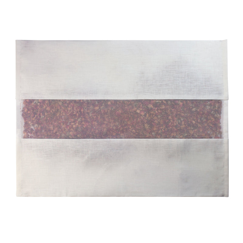 A white envelope with a translucent window reveals dried flower petals inside, evoking the elegance of the elizabeth W Rose Drawer Liner Ivory Linen by elizabeth W, set against a plain white background.