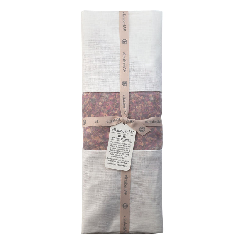 The elizabeth W Rose Drawer Liner Ivory Linen is folded and tied with a beige ribbon, featuring a label and tag. The center displays an elegant pink and green floral rose design, highlighting the scented ivory linen liner by elizabeth W.