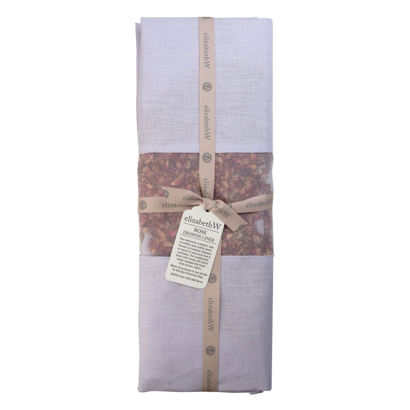 The elizabeth W Rose Drawer Liner Purple Linen comes in a folded lavender linen bag with a beige ribbon and "elizabeth W" tag. The bag pairs perfectly with the drawer liner and contains rose-scented potpourri visible through a clear window.